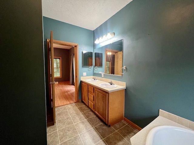 876 N Sanford Ln, Au Gres, MI 48703 - full bathroom with tile patterned floors, double vanity, a textured ceiling, and a garden tub