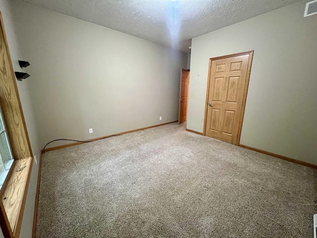 876 N Sanford Ln, Au Gres, MI 48703 - carpeted empty room featuring a textured ceiling and baseboards