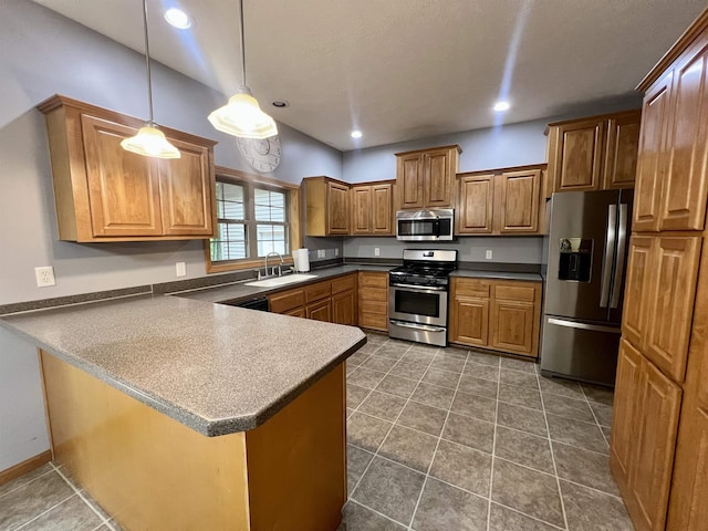 876 N Sanford Ln, Au Gres, MI 48703 - kitchen featuring appliances with stainless steel finishes, a peninsula, brown cabinetry, pendant lighting, and dark countertops