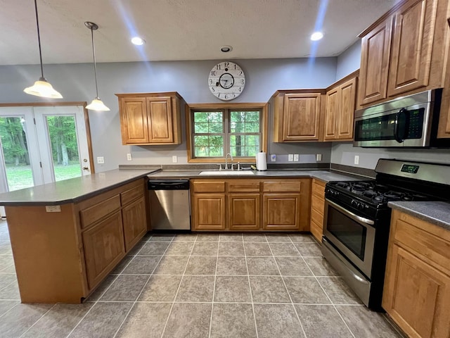 876 N Sanford Ln, Au Gres, MI 48703 - kitchen featuring appliances with stainless steel finishes, a peninsula, healthy amount of natural light, dark countertops, and recessed lighting