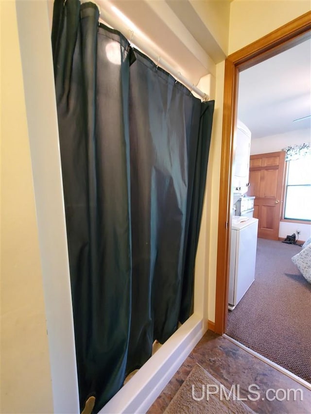 1249 Cedar St, Hancock, MI 49930 - full bathroom with stacked washing machine and dryer and a shower with shower curtain