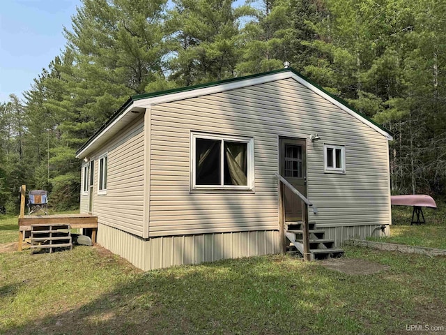 E8310 County Road 440th Hwy, Wetmore, MI 49895 - view of side of home with entry steps, a lawn, and a deck