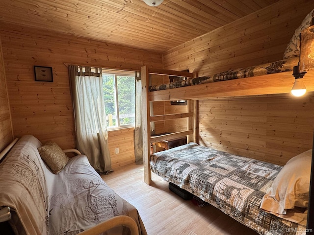 E8310 County Road 440th Hwy, Wetmore, MI 49895 - bedroom with wood walls, light wood-style flooring, and wooden ceiling