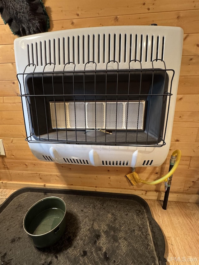 E8310 County Road 440th Hwy, Wetmore, MI 49895 - detailed view of heating unit, wood walls, and wood finished floors