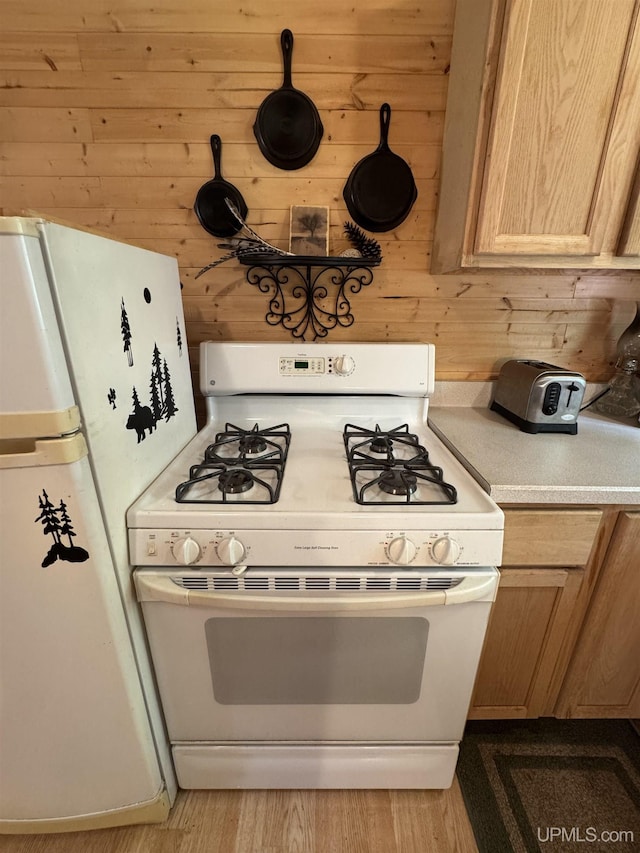 E8310 County Road 440th Hwy, Wetmore, MI 49895 - kitchen featuring white appliances, light countertops, wood walls, and wood finished floors