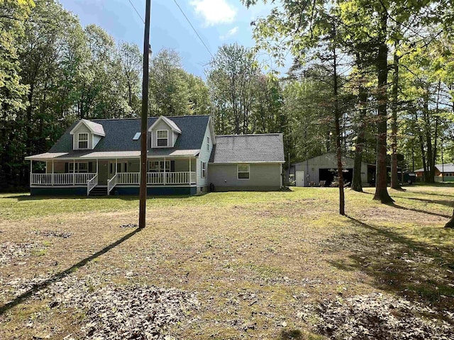 8855 Scotty Dr, Lake, MI 48632 - rear view of property featuring a porch and a detached garage
