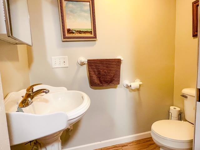 8855 Scotty Dr, Lake, MI 48632 - half bath with toilet and wood finished floors