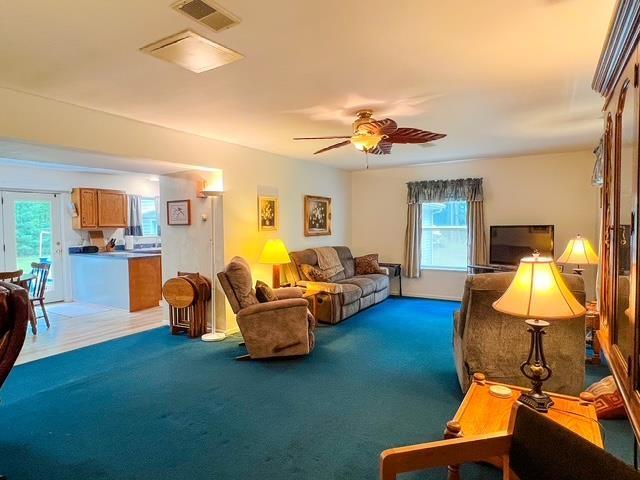 8855 Scotty Dr, Lake, MI 48632 - living room featuring light carpet and ceiling fan