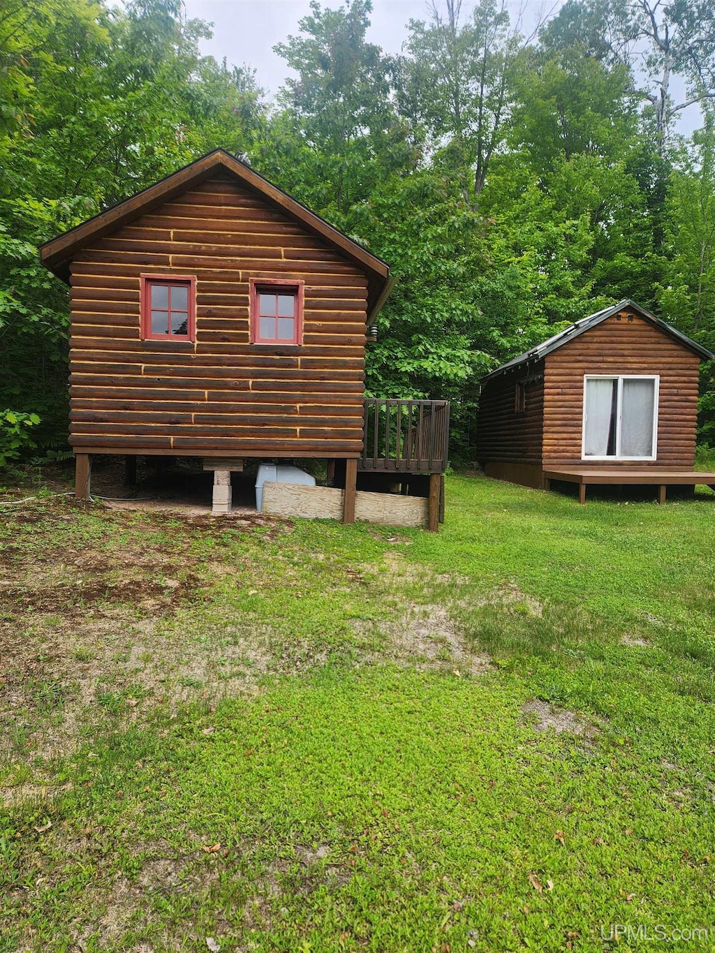 33289 Telephone Rd Unit 3, Toivola, MI 49965 - view of side of property featuring a wooden deck, a yard, and an outbuilding