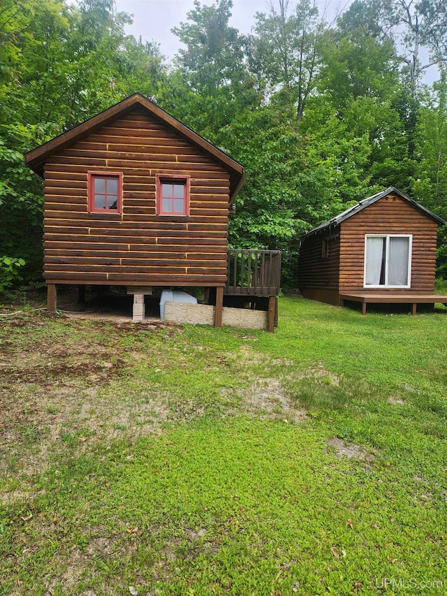 33289 Telephone Rd Unit 3, Toivola, MI 49965 - view of side of property featuring a wooden deck, a yard, and an outbuilding