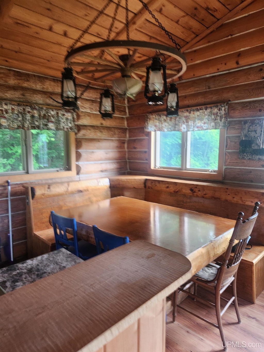 33289 Telephone Rd Unit 3, Toivola, MI 49965 - dining area featuring log walls, breakfast area, wooden ceiling, wood finished floors, and vaulted ceiling
