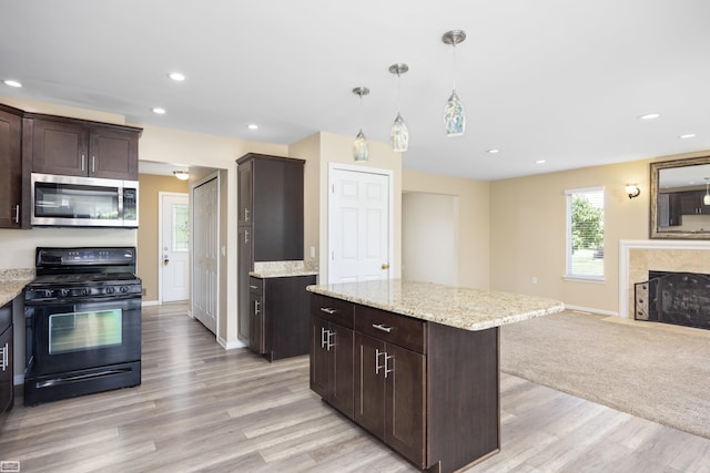 46395 Greenbriar St, Chesterfield Twp, MI 48051 - kitchen featuring black range with gas stovetop, stainless steel microwave, light wood-style flooring, dark brown cabinets, and open floor plan