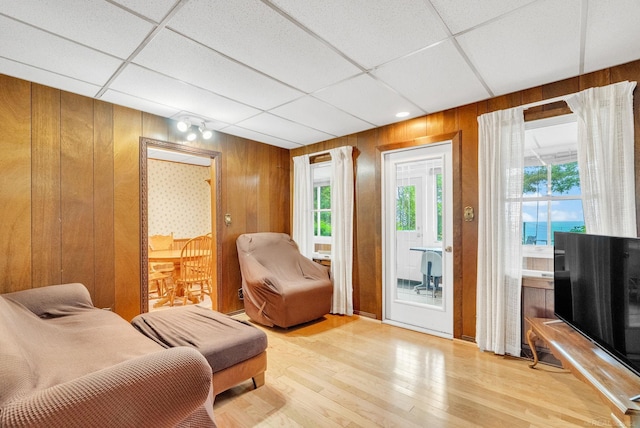 1159 S Lakeshore Rd, Carsonville, MI 48419 - living area with wooden walls, wood finished floors, healthy amount of natural light, and a drop ceiling