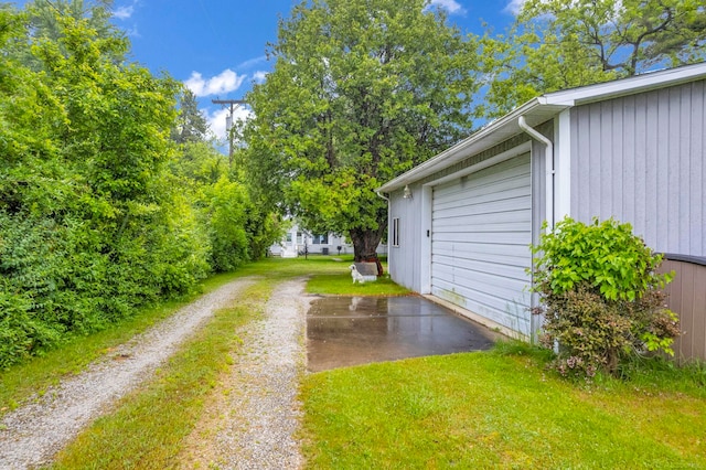 1159 S Lakeshore Rd, Carsonville, MI 48419 - view of grassy yard featuring driveway and a garage