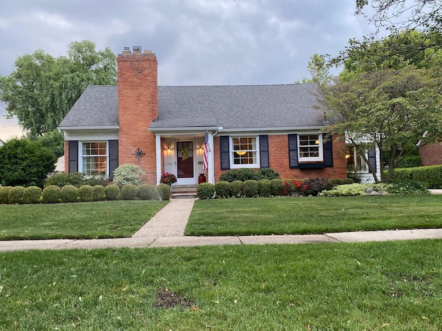 1782 Hollywood St, Grosse Pointe Woods, MI 48236 - view of front of property with a chimney, a front lawn, brick siding, and roof with shingles