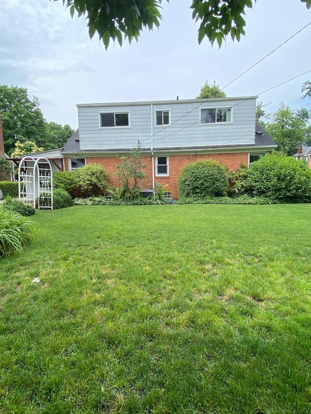 1782 Hollywood St, Grosse Pointe Woods, MI 48236 - rear view of house with brick siding and a lawn