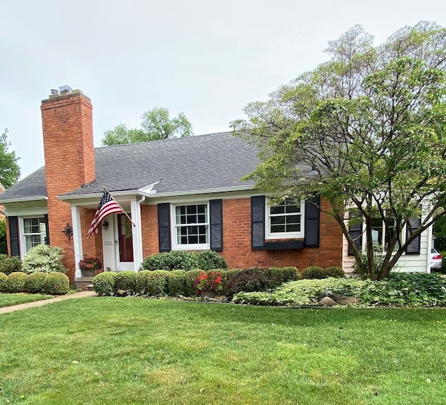 1782 Hollywood St, Grosse Pointe Woods, MI 48236 - view of front facade with a front lawn, roof with shingles, a chimney, and brick siding