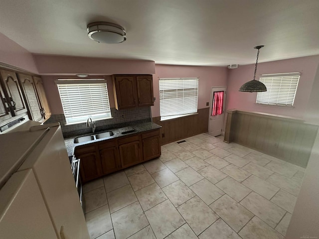 23072 Rein Ave, Eastpointe, MI 48021 - kitchen with wainscoting, plenty of natural light, wood walls, pendant lighting, and backsplash