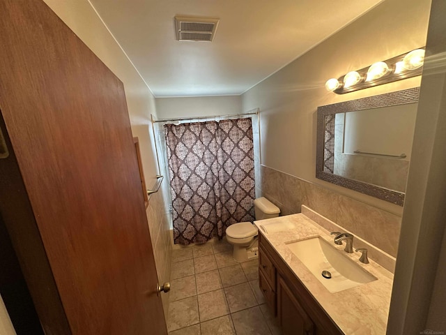 23072 Rein Ave, Eastpointe, MI 48021 - full bathroom featuring vanity, curtained shower, tile patterned flooring, tile walls, and wainscoting