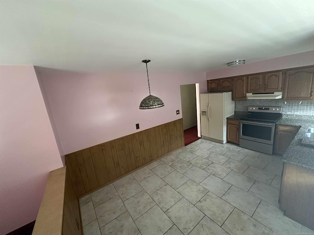 23072 Rein Ave, Eastpointe, MI 48021 - kitchen featuring electric stove, white fridge with ice dispenser, under cabinet range hood, wooden walls, and a wainscoted wall