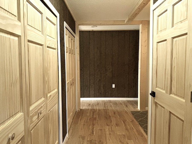 3331 Lakeshore Dr, Gladwin, MI 48624 - hall with wood finished floors, a textured ceiling, and wood walls