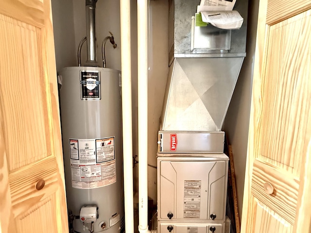 3331 Lakeshore Dr, Gladwin, MI 48624 - utility room featuring gas water heater and heating unit