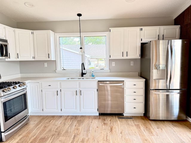3331 Lakeshore Dr, Gladwin, MI 48624 - kitchen with stainless steel appliances, white cabinetry, and light countertops