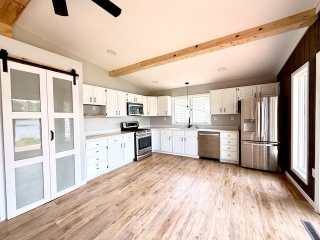 3331 Lakeshore Dr, Gladwin, MI 48624 - kitchen featuring appliances with stainless steel finishes, light wood finished floors, light countertops, a ceiling fan, and recessed lighting