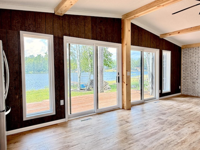 3331 Lakeshore Dr, Gladwin, MI 48624 - doorway to outside with beam ceiling, wood walls, a water view, light wood finished floors, and ceiling fan
