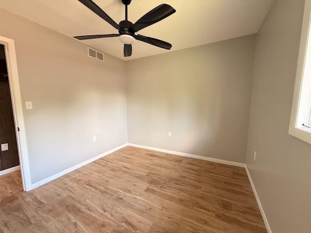 3331 Lakeshore Dr, Gladwin, MI 48624 - empty room with wood finished floors and ceiling fan