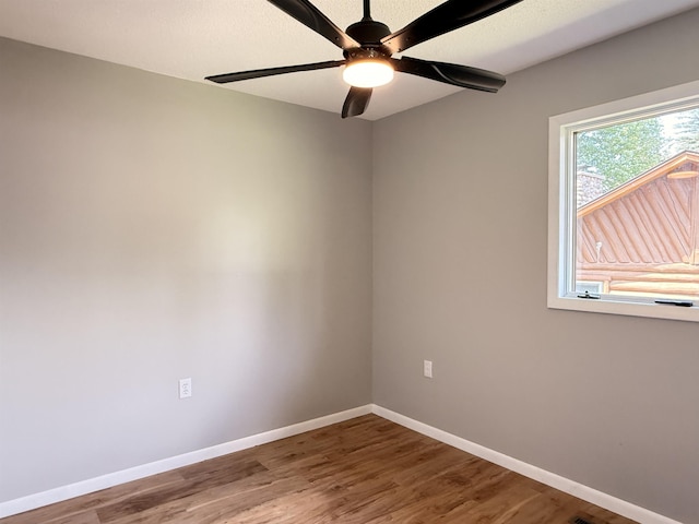 3331 Lakeshore Dr, Gladwin, MI 48624 - empty room featuring wood finished floors and a ceiling fan
