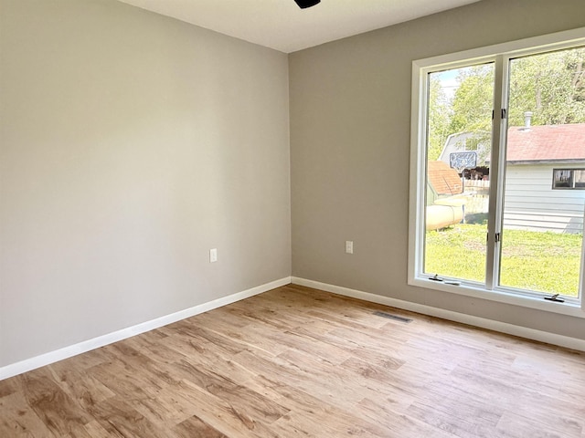 3331 Lakeshore Dr, Gladwin, MI 48624 - spare room featuring healthy amount of natural light, light wood-style flooring, and ceiling fan