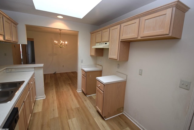 11186 Spruce Ct Unit 105, Washington Twp, MI 48094 - kitchen with under cabinet range hood, light wood finished floors, a chandelier, dishwasher, and recessed lighting