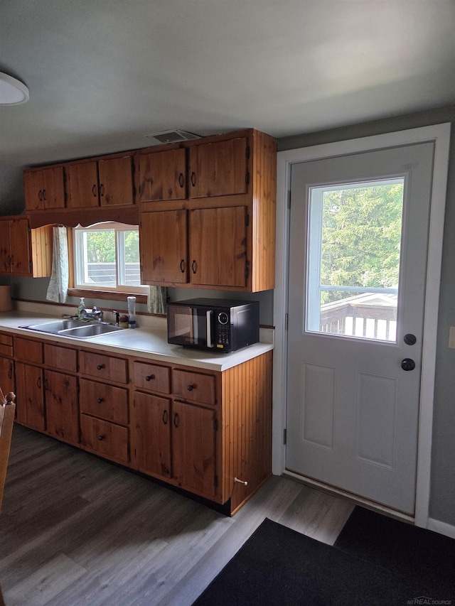 321 Lamson St, Grand Ledge, MI 48837 - kitchen featuring black microwave, light wood-style floors, light countertops, and brown cabinets