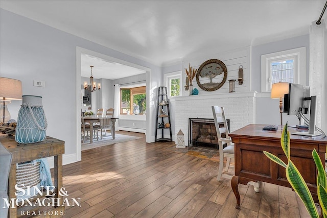 421 Edgewater Dr, Algonac, MI 48001 - office area with a baseboard heating unit, hardwood / wood-style flooring, a brick fireplace, and a chandelier