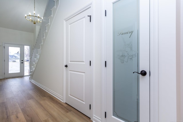 27602 Maryjane Ln E, Chesterfield Twp, MI 48047 - corridor featuring stairway, a chandelier, and light wood-type flooring