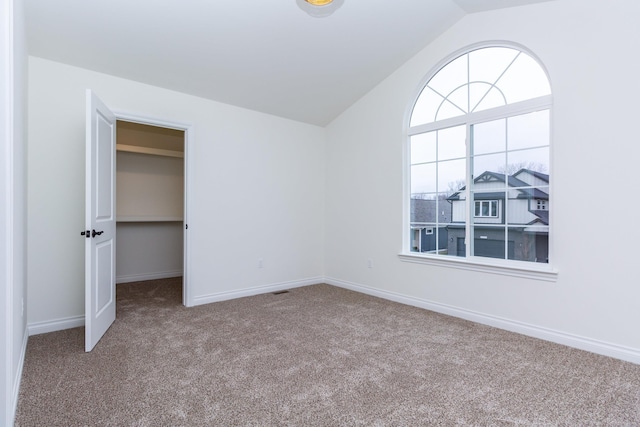 27602 Maryjane Ln E, Chesterfield Twp, MI 48047 - unfurnished bedroom with carpet floors, vaulted ceiling, and a spacious closet