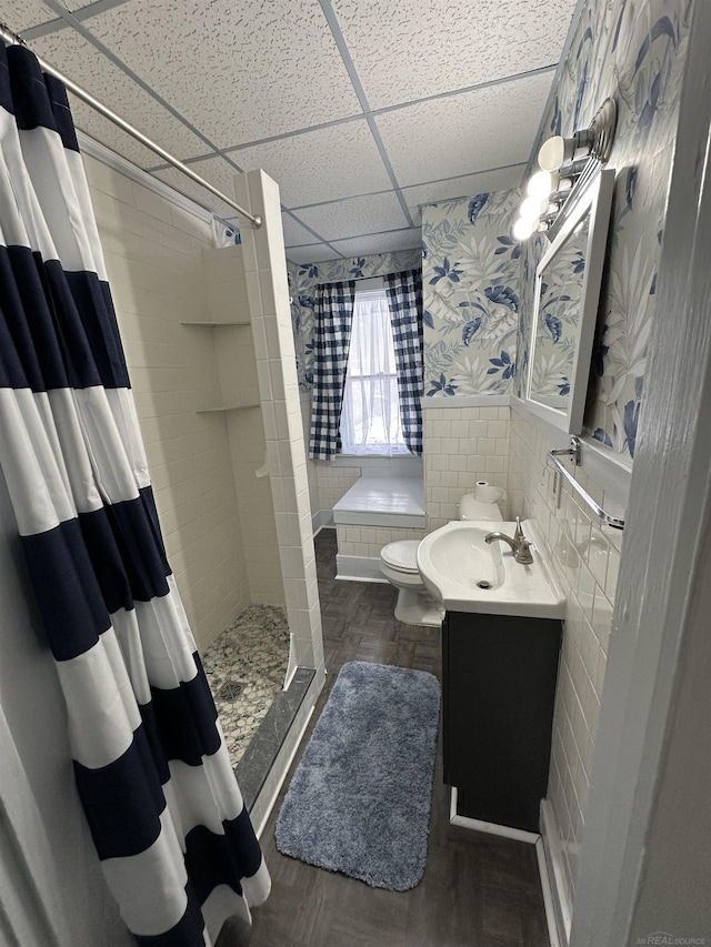 734 Court St, Port Huron, MI 48060 - full bath with a drop ceiling, a stall shower, vanity, a wainscoted wall, and tile walls
