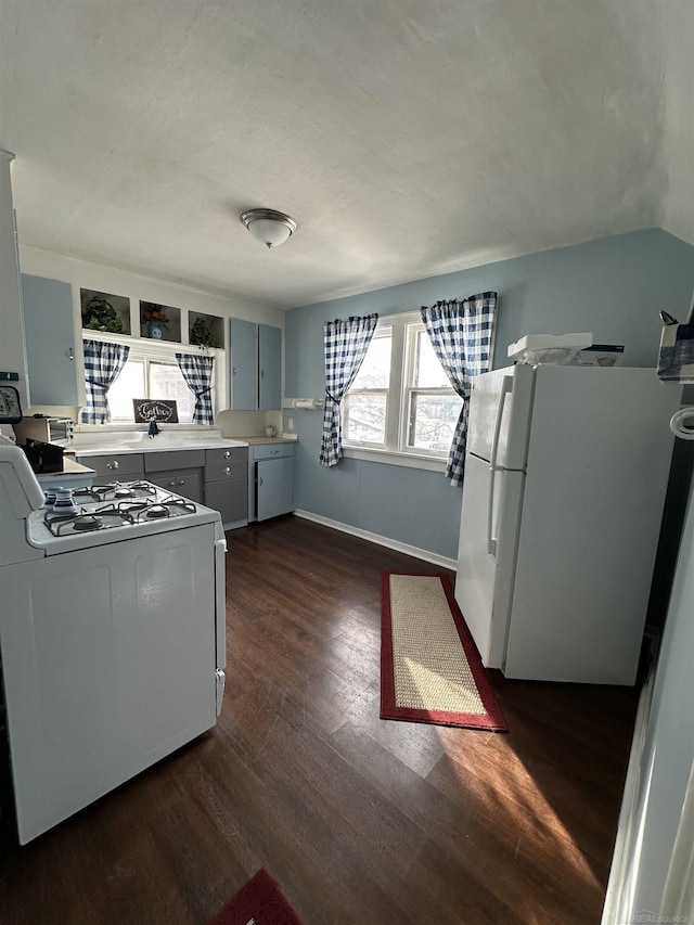 734 Court St, Port Huron, MI 48060 - kitchen featuring white appliances, dark wood-style flooring, light countertops, and gray cabinets