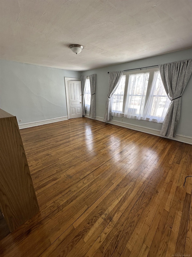 734 Court St, Port Huron, MI 48060 - unfurnished room with wood-type flooring and a textured ceiling