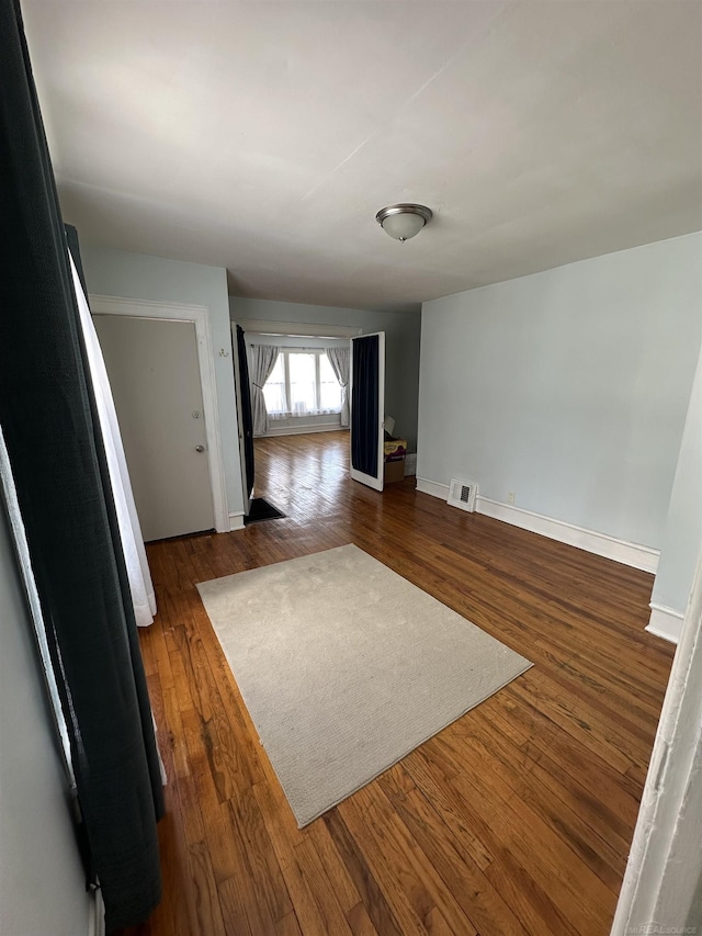 734 Court St, Port Huron, MI 48060 - empty room with dark wood finished floors and baseboards