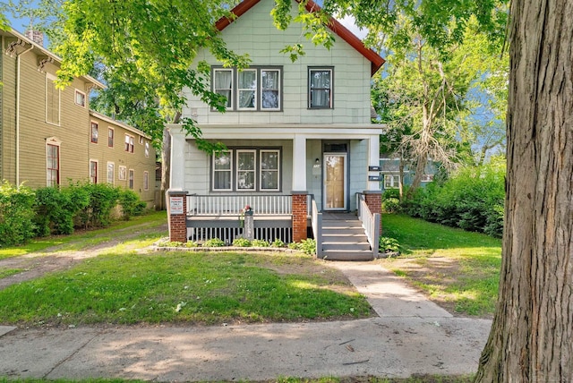 734 Court St, Port Huron, MI 48060 - view of front facade featuring a porch and a front lawn