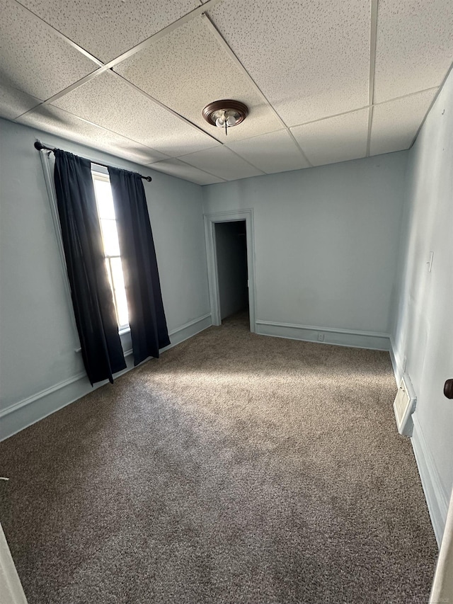 734 Court St, Port Huron, MI 48060 - carpeted empty room featuring a paneled ceiling and baseboards