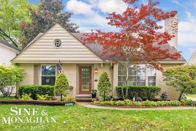 1387 Torrey Rd, Grosse Pointe Woods, MI 48236 - view of front of property featuring brick siding, a front lawn, a chimney, and roof with shingles