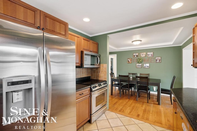 1387 Torrey Rd, Grosse Pointe Woods, MI 48236 - kitchen with appliances with stainless steel finishes, light tile patterned floors, tasteful backsplash, crown molding, and recessed lighting
