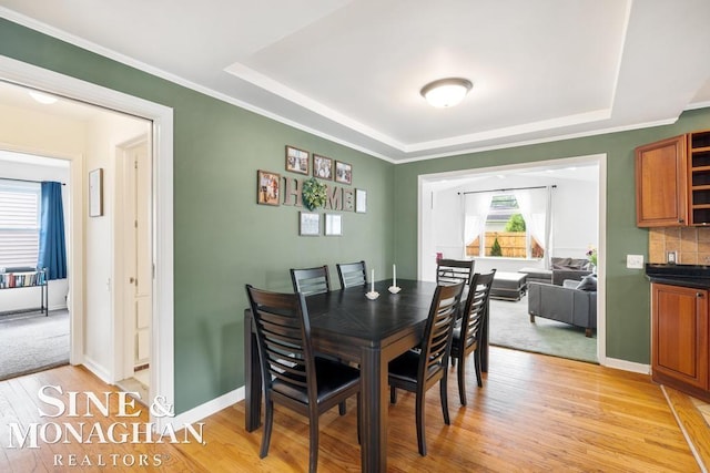 1387 Torrey Rd, Grosse Pointe Woods, MI 48236 - dining room with a raised ceiling, light wood-style floors, and crown molding