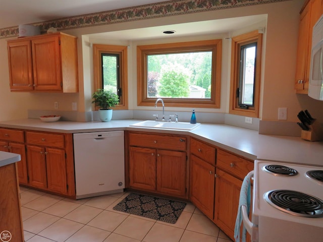 46778 Tiffin Ct, Chesterfield, MI 48047 - kitchen featuring white dishwasher, light countertops, light tile patterned flooring, and brown cabinetry