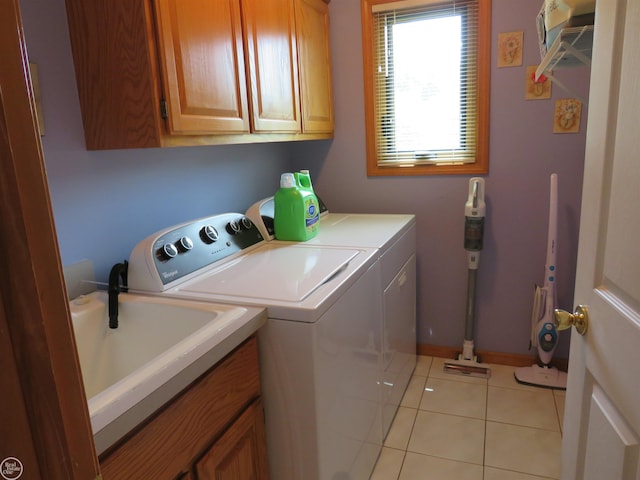46778 Tiffin Ct, Chesterfield, MI 48047 - laundry area featuring washing machine and dryer, cabinet space, and light tile patterned flooring