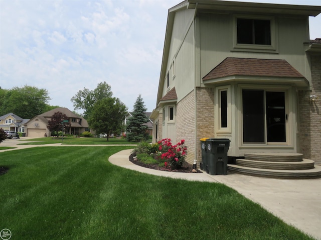 46778 Tiffin Ct, Chesterfield, MI 48047 - view of side of property featuring entry steps, a yard, brick siding, and a residential view