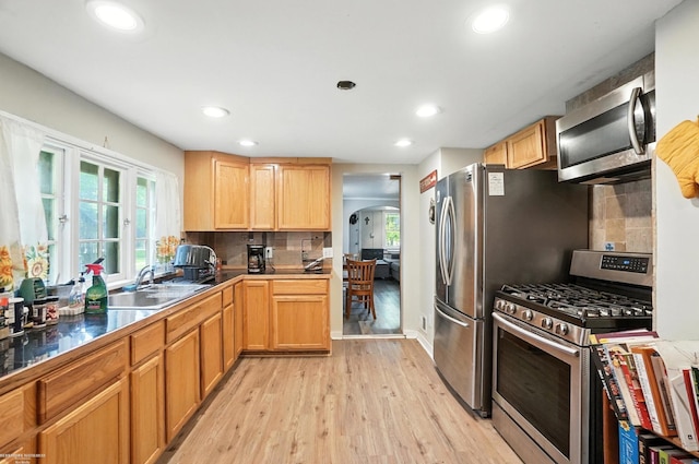 618 Harrison St, Monroe, MI 48161 - kitchen with appliances with stainless steel finishes, arched walkways, light wood-style floors, plenty of natural light, and recessed lighting